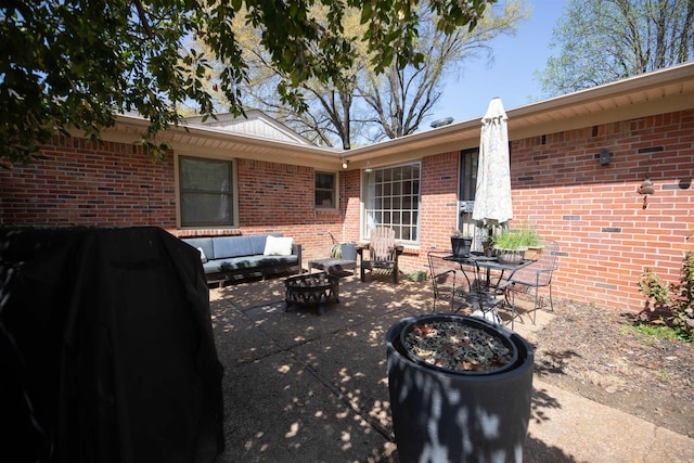 view of patio / terrace with an outdoor living space with a fire pit and grilling area