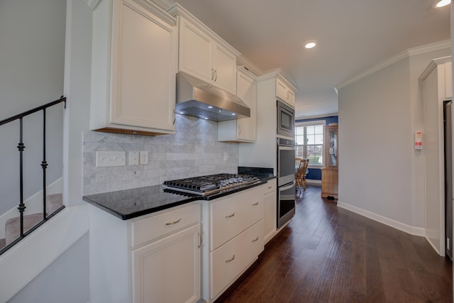 kitchen with crown molding, tasteful backsplash, under cabinet range hood, appliances with stainless steel finishes, and dark wood-style floors