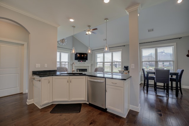 kitchen featuring dishwasher, a sink, a ceiling fan, and dark countertops