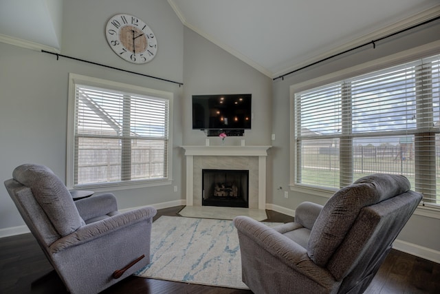living room with a high end fireplace, ornamental molding, wood finished floors, lofted ceiling, and baseboards