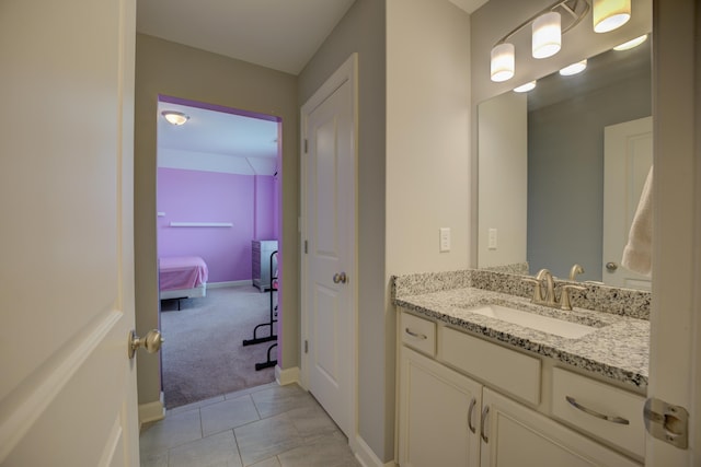 bathroom featuring tile patterned flooring, baseboards, and vanity