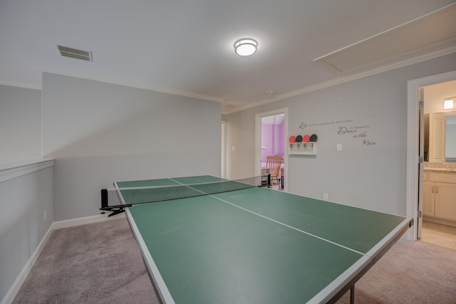 recreation room featuring light carpet, attic access, ornamental molding, and visible vents