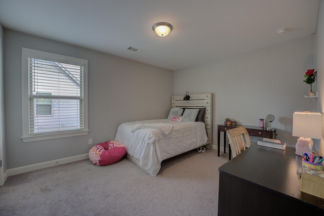 carpeted bedroom featuring visible vents and baseboards