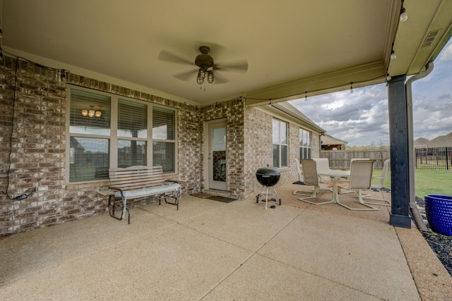 view of patio / terrace featuring a ceiling fan, area for grilling, and fence