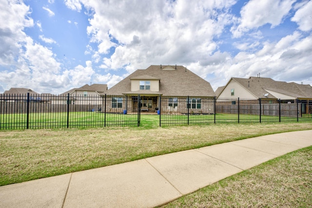 view of front facade featuring a front yard and fence