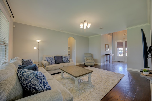 living room with arched walkways, dark wood-style flooring, crown molding, and visible vents