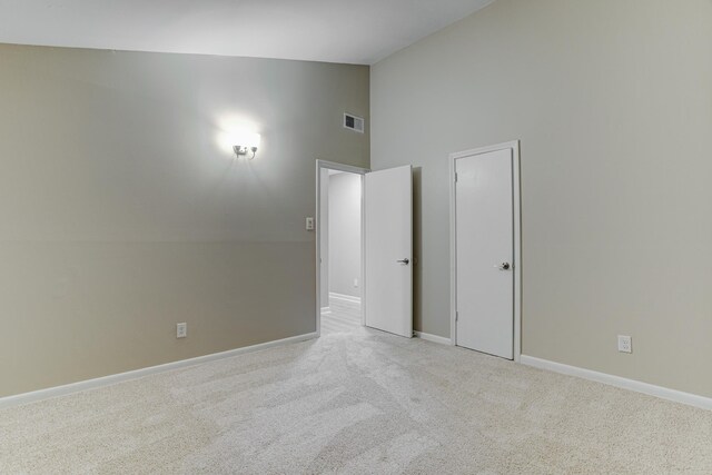 3562 Pueblo Ave, Memphis, TN 38127 - empty room with visible vents, baseboards, high vaulted ceiling, and carpet floors