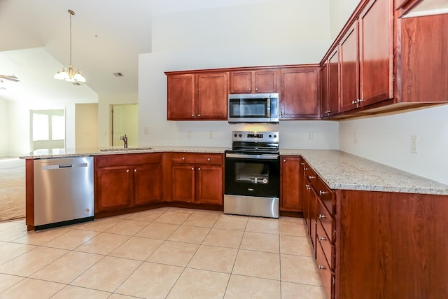 kitchen featuring light stone countertops, a peninsula, appliances with stainless steel finishes, a sink, and a notable chandelier