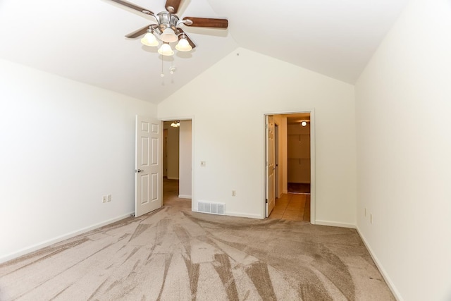 unfurnished bedroom featuring a ceiling fan, vaulted ceiling, visible vents, carpet flooring, and baseboards