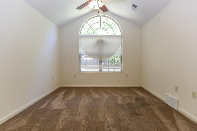 unfurnished room with carpet flooring, a ceiling fan, visible vents, and plenty of natural light