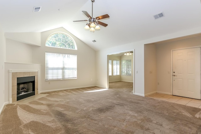 unfurnished living room with light carpet, ceiling fan, a fireplace, and visible vents