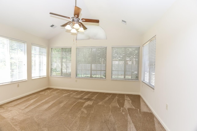 unfurnished sunroom with carpet, visible vents, baseboards, and vaulted ceiling