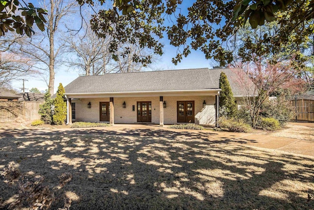 344 Perkins Ext, Memphis, TN 38117 - ranch-style home featuring french doors, a shingled roof, fence, and brick siding