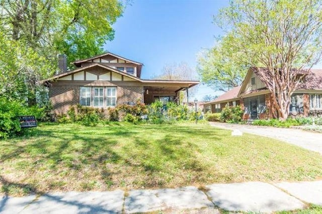 1486 Eastmoreland Ave, Memphis, TN 38104 - view of front of house with brick siding, a front lawn, and a chimney