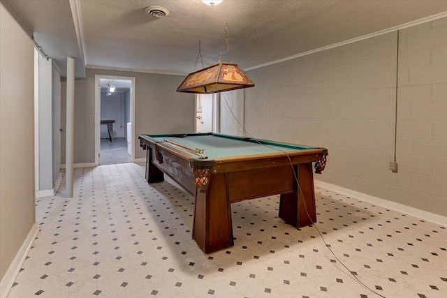 rec room with visible vents, ornamental molding, a textured ceiling, billiards, and concrete block wall
