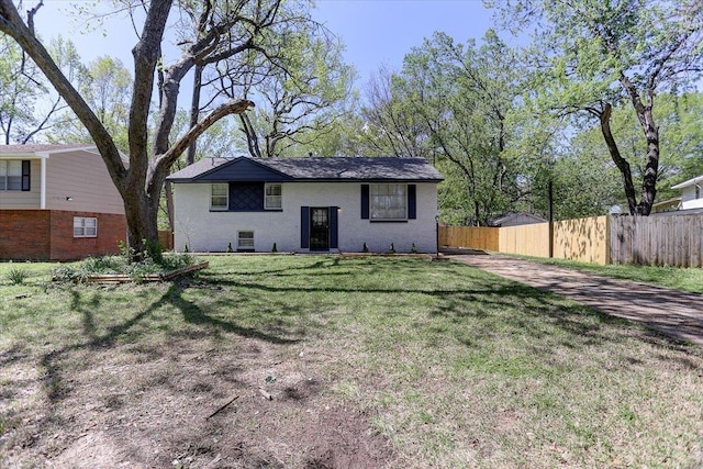 back of house with a yard and fence