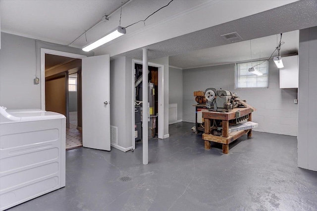basement with visible vents, washer / dryer, and concrete block wall