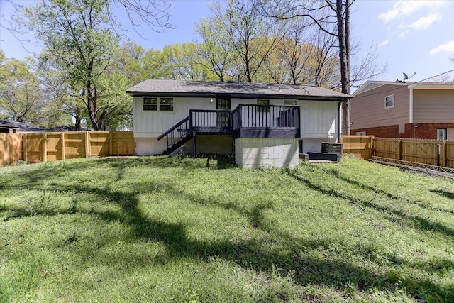 rear view of house featuring a yard, a fenced backyard, central AC unit, and stairs