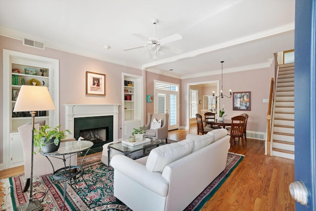 1005 River Currents Dr, Memphis, TN 38103 - living room featuring stairs, visible vents, light wood-type flooring, and built in features