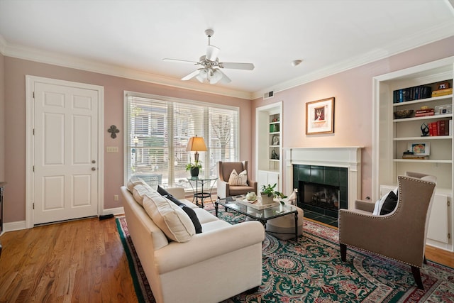 1005 River Currents Dr, Memphis, TN 38103 - living room featuring crown molding, ceiling fan, wood finished floors, and a fireplace
