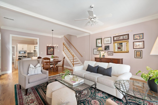 1005 River Currents Dr, Memphis, TN 38103 - living area with ornamental molding, baseboards, light wood-type flooring, and stairs