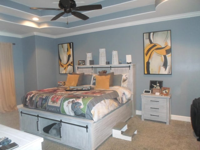 bedroom featuring baseboards, carpet flooring, a tray ceiling, and crown molding
