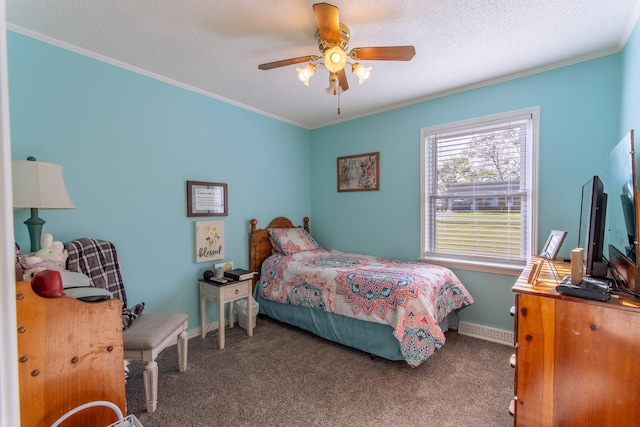 carpeted bedroom with ceiling fan, a textured ceiling, ornamental molding, visible vents, and baseboards