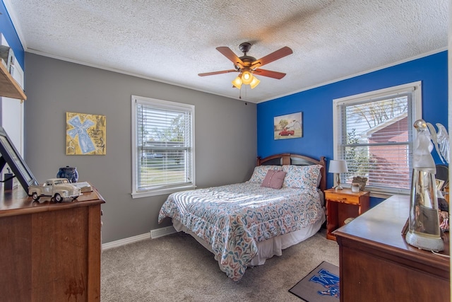 carpeted bedroom with a textured ceiling, baseboards, multiple windows, and a ceiling fan