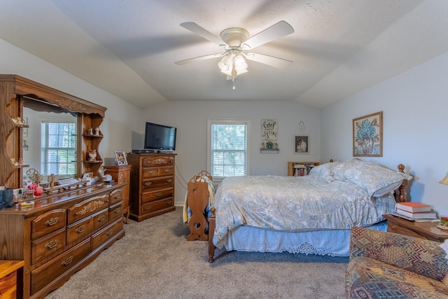 carpeted bedroom featuring a ceiling fan and lofted ceiling