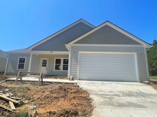 view of front of home with concrete driveway and an attached garage