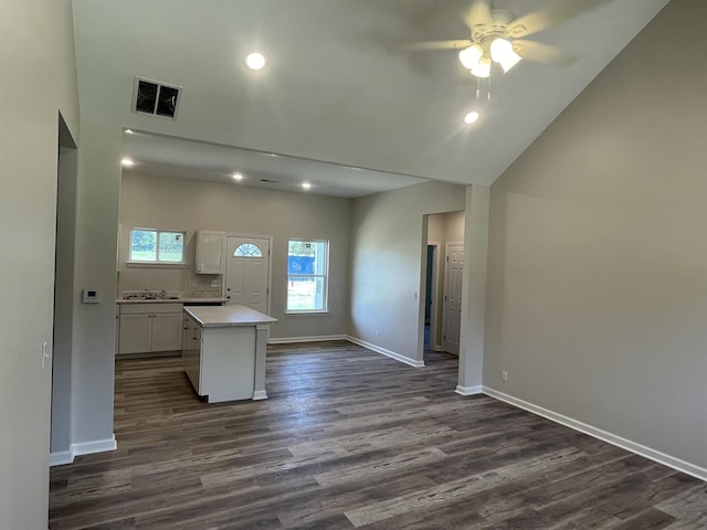 interior space with white cabinets, a wealth of natural light, visible vents, and ceiling fan
