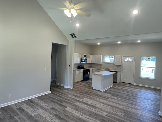 kitchen featuring recessed lighting, stainless steel appliances, high vaulted ceiling, and a center island
