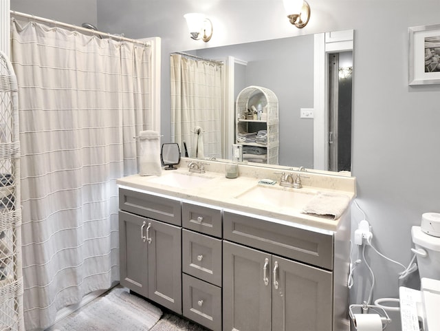 full bathroom with toilet, vanity, and a shower with curtain