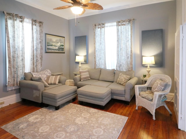living room featuring crown molding, wood-type flooring, ceiling fan, and baseboards
