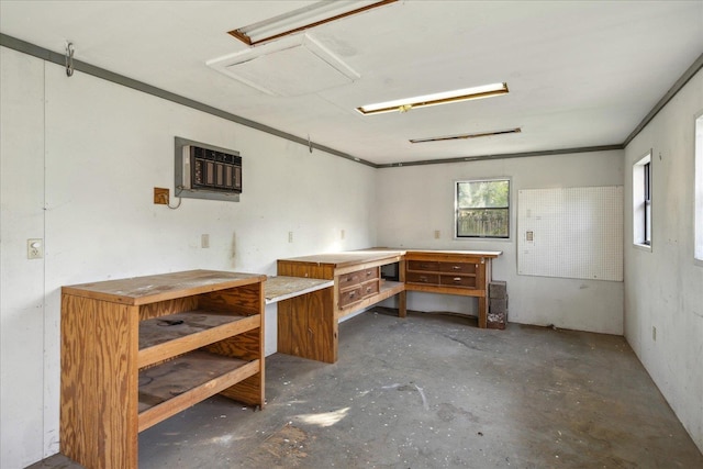 below grade area with an AC wall unit and a workshop area