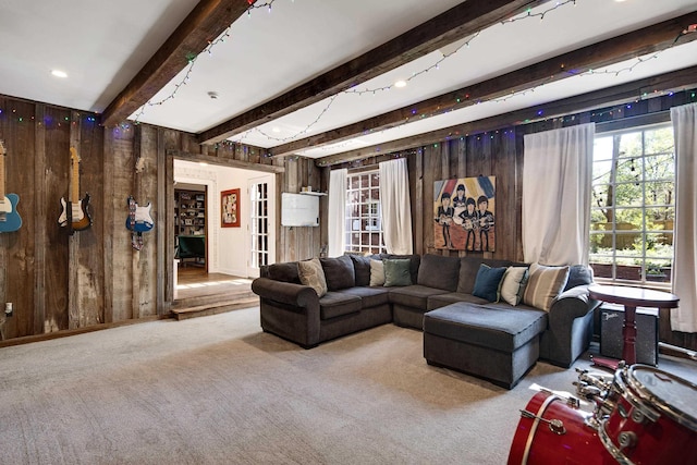 4252 Heatherwood Ln, Memphis, TN 38117 - carpeted living room featuring wooden walls, plenty of natural light, and beam ceiling
