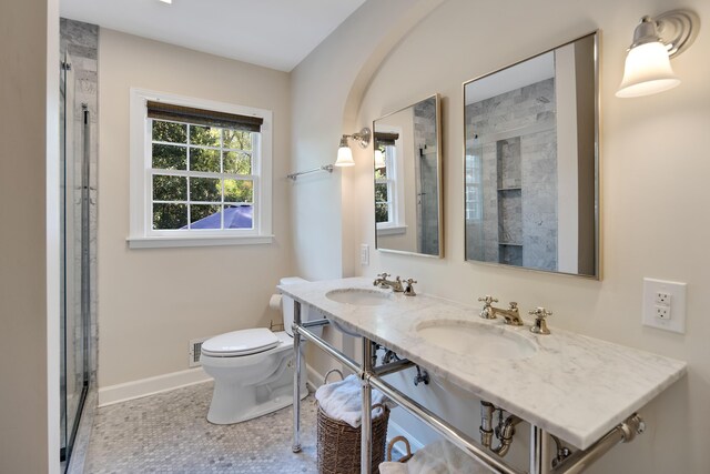 4252 Heatherwood Ln, Memphis, TN 38117 - bathroom featuring baseboards, a sink, a stall shower, and toilet