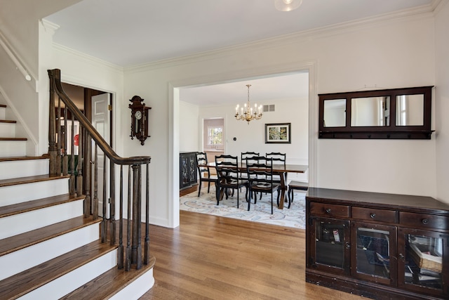 4252 Heatherwood Ln, Memphis, TN 38117 - interior space featuring a notable chandelier, stairs, wood finished floors, visible vents, and ornamental molding