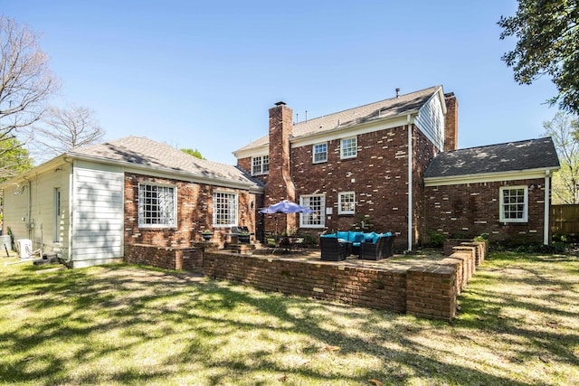 4252 Heatherwood Ln, Memphis, TN 38117 - rear view of property featuring a yard, brick siding, an outdoor living space, and a chimney