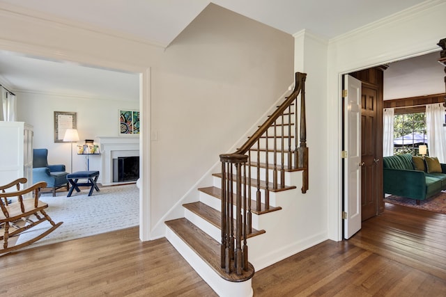 4252 Heatherwood Ln, Memphis, TN 38117 - stairs featuring a fireplace with raised hearth, baseboards, ornamental molding, and wood finished floors