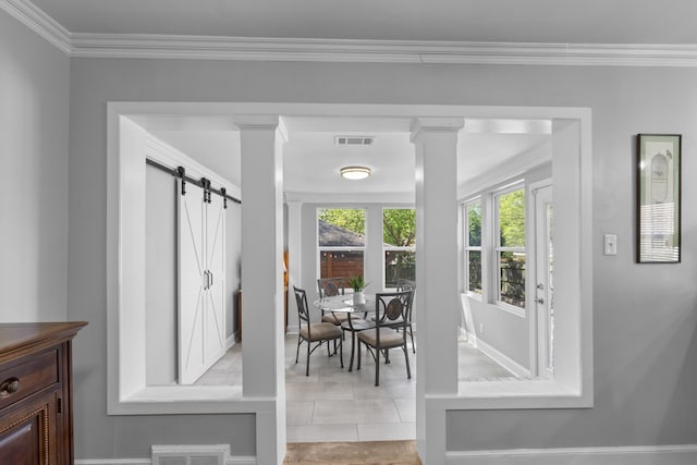 dining area featuring crown molding, visible vents, ornate columns, and a barn door