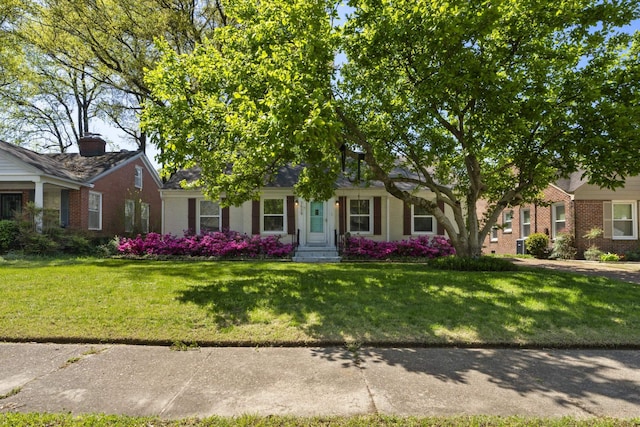 view of front facade featuring a front lawn and brick siding