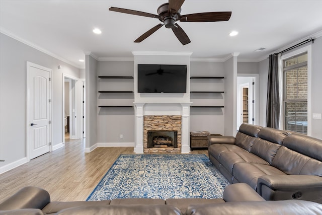 6742 Malone Rd, Olive Branch, MS 38654 - living room featuring crown molding, ceiling fan, a fireplace, light wood-style flooring, and baseboards