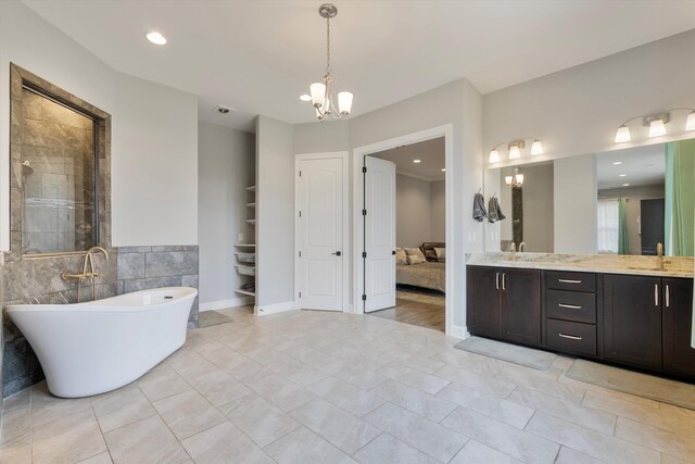 6742 Malone Rd, Olive Branch, MS 38654 - full bath with vanity, a stall shower, a soaking tub, a chandelier, and tile patterned floors