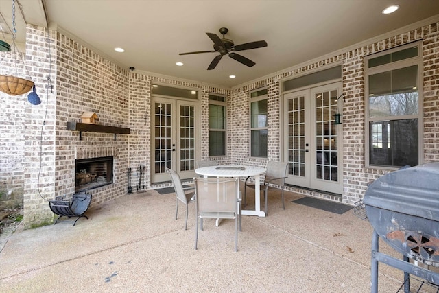 6742 Malone Rd, Olive Branch, MS 38654 - view of patio featuring a grill, an outdoor brick fireplace, ceiling fan, outdoor dining space, and french doors