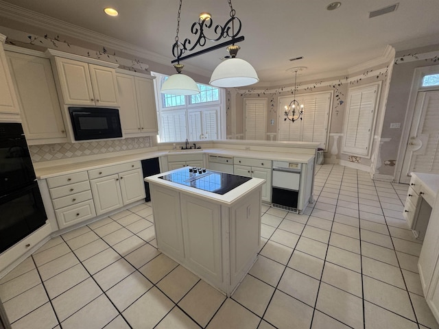 kitchen with an inviting chandelier, light tile patterned floors, a center island, visible vents, and black appliances