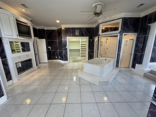 full bathroom featuring a ceiling fan, decorative columns, ornamental molding, and tile walls