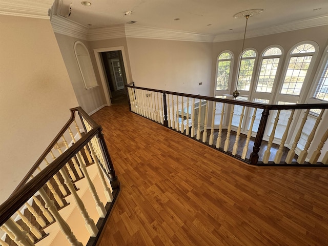 hall featuring crown molding, wood finished floors, and an upstairs landing