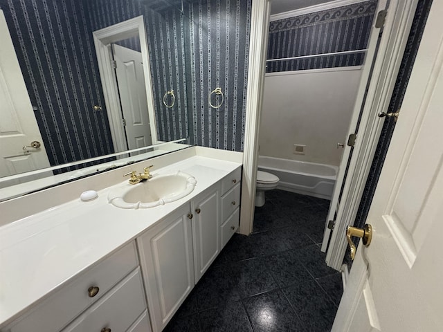 bathroom with tile patterned flooring, vanity, wallpapered walls, and toilet