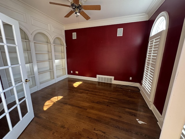 unfurnished room featuring visible vents, baseboards, ceiling fan, crown molding, and wood finished floors